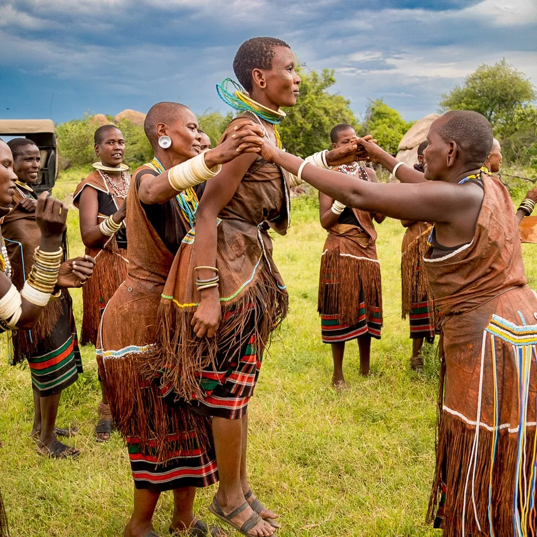 Datoga women in beaded leather dresses and brass ornaments dancing near Lake Eyasi, Tanzania